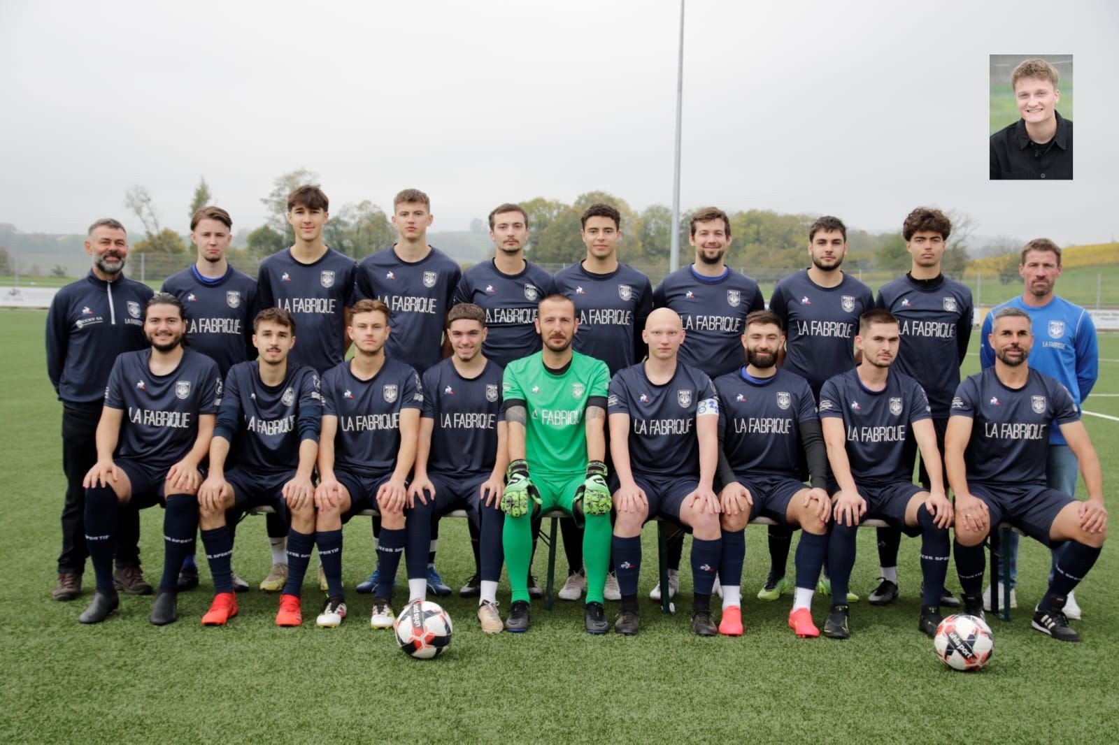 Soccer team posing on a field in blue jerseys, with one player in green goalkeeper attire.